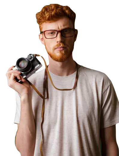 a red-haired man with a camera in his hands